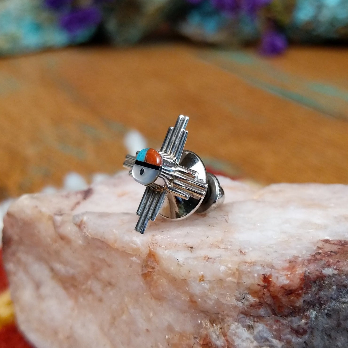 Sterling silver Zuni tie tack with sun symbol-inspired design and multistone center.