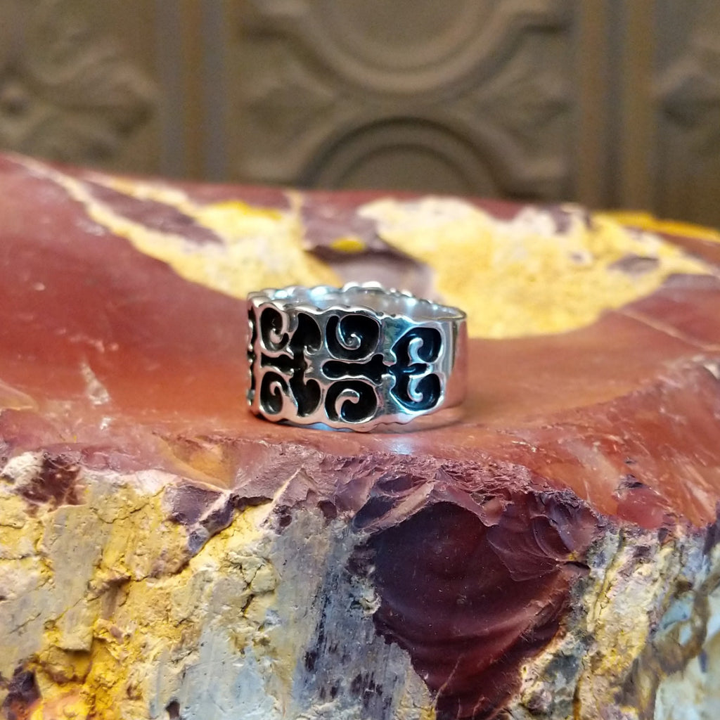 Sterling silver ring with symmetrical geometric patterns all along the band.