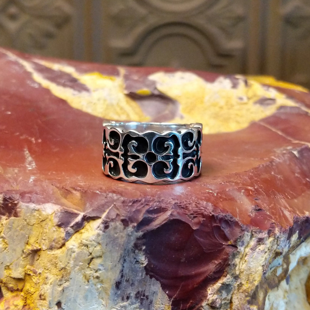 Sterling silver ring with symmetrical geometric patterns all along the band.