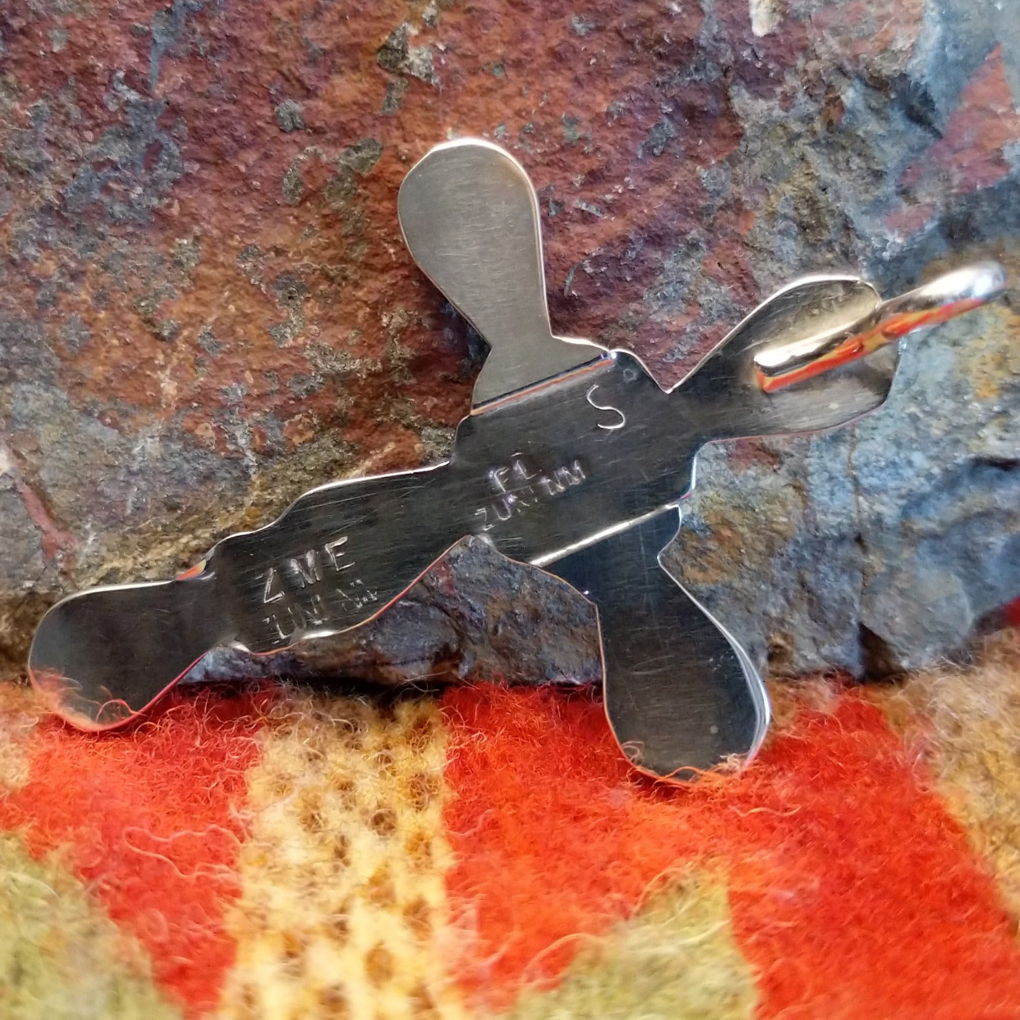 Zuni sterling silver teardrop inlay cross pendant by Zeno and Maryann Edaakie, showing artisan hallmark