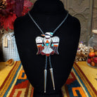 Zuni Thunderbird Bolo Tie by Bobby Shack featuring a detailed silver thunderbird with colorful turquoise, coral red, white, and black geometric inlay, outstretched wings, braided black leather cord, and polished silver tips.
