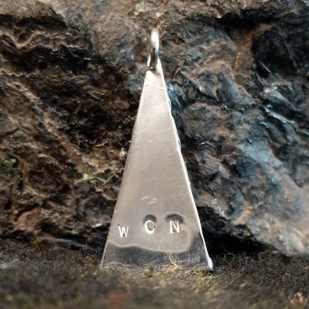 The back features the artisans stamped initials.