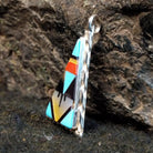 Various stones inlaid in a triangular sterling silver bezel.
