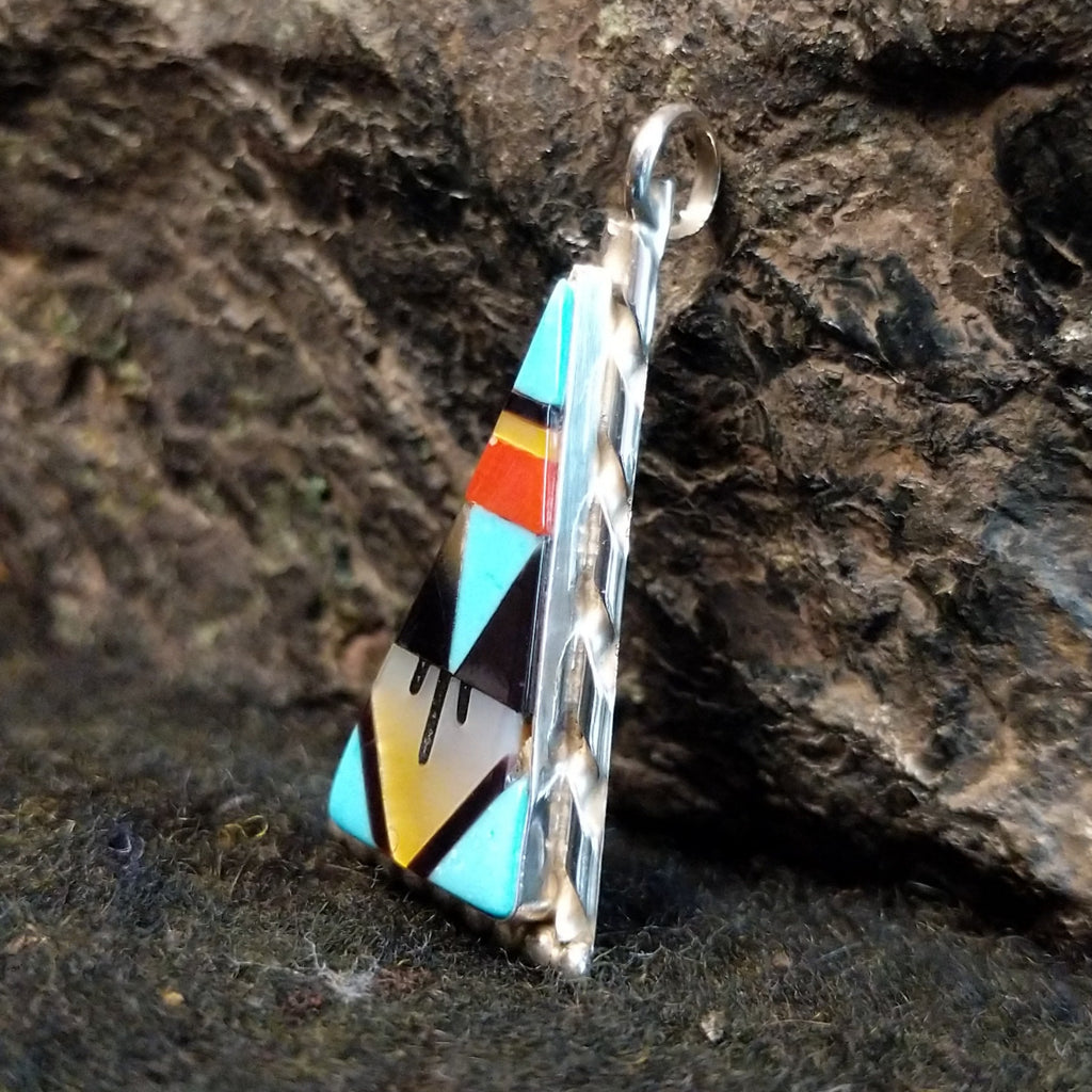 Various stones inlaid in a triangular sterling silver bezel.