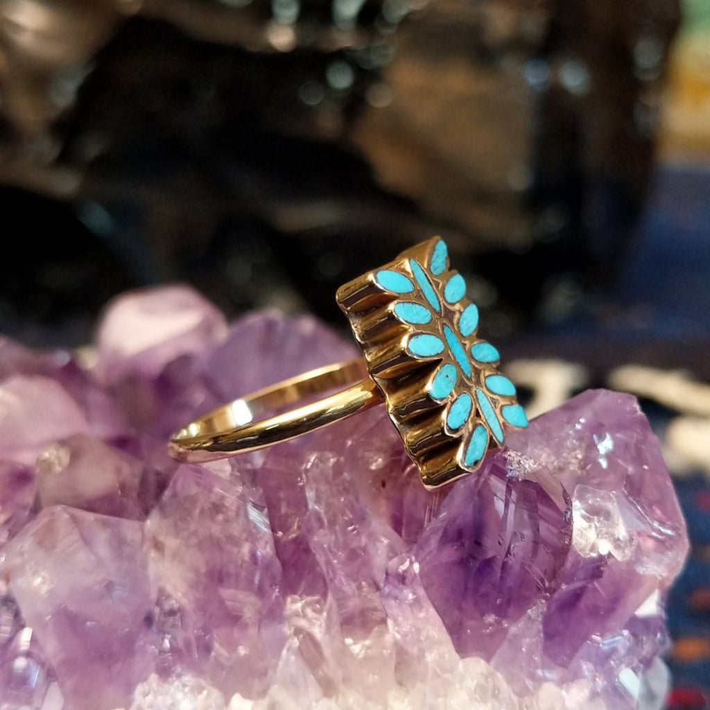 Side view of the ring revealing the slim gold band and elevated inlay surface.