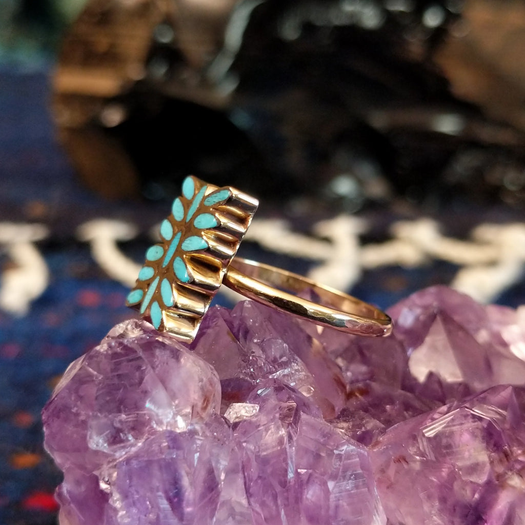 Side view of the ring revealing the slim gold band and elevated inlay surface.