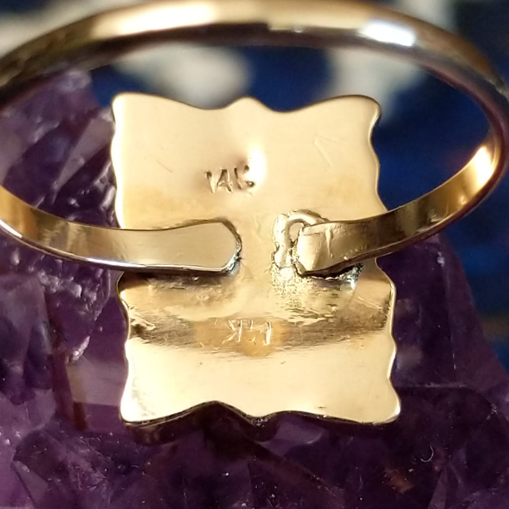 The gold and maker's mark is stamped into the inside of the motif.