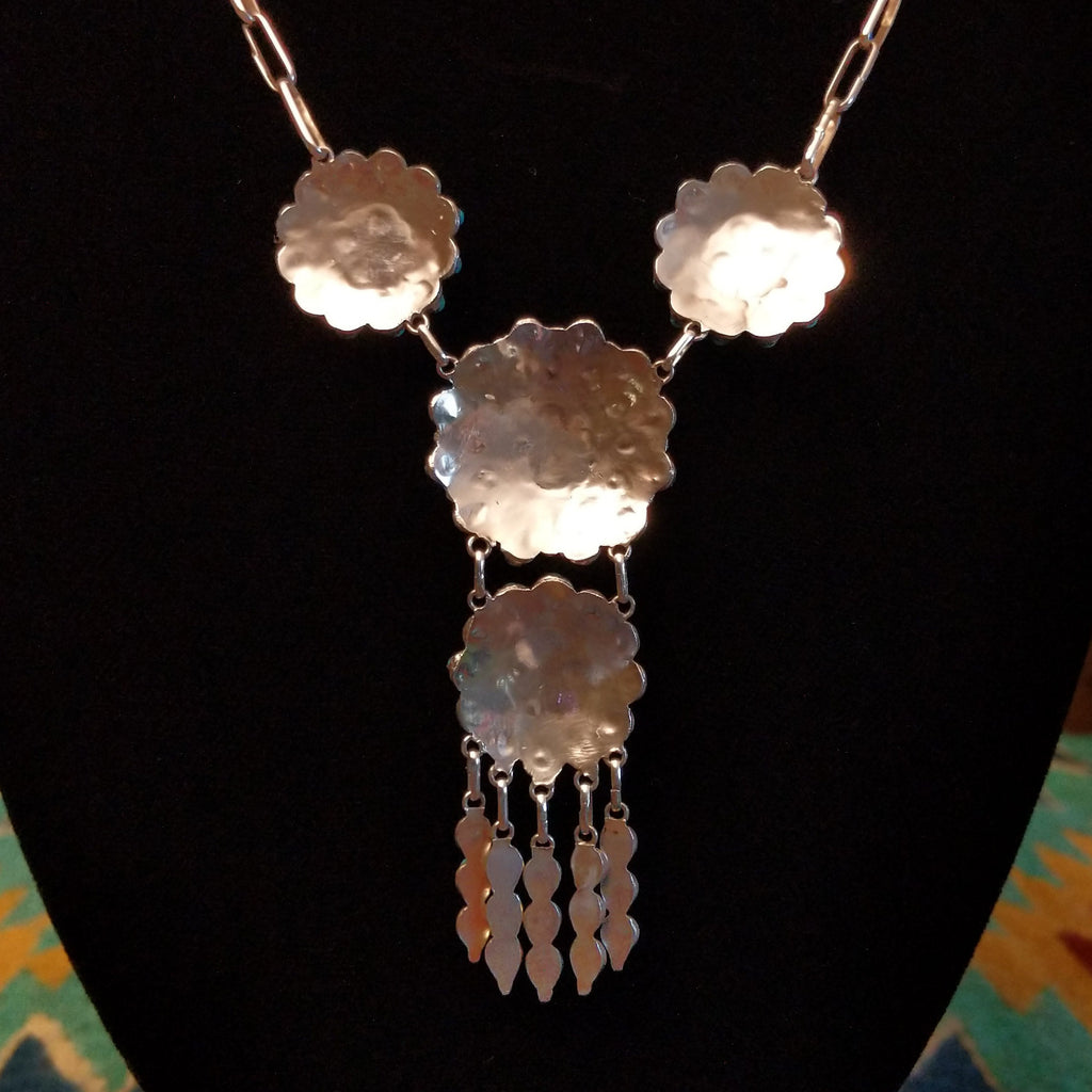 The back features the sterling silver pendants.