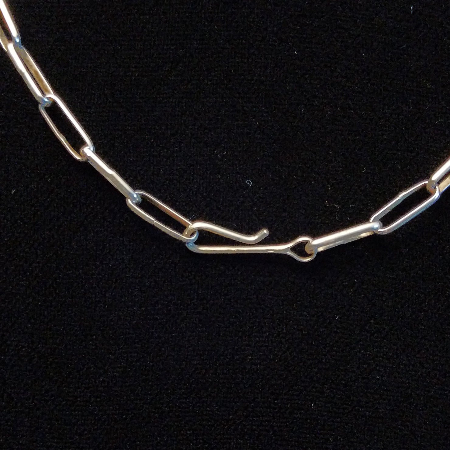 Close-up of the hook clasp on the necklace.
