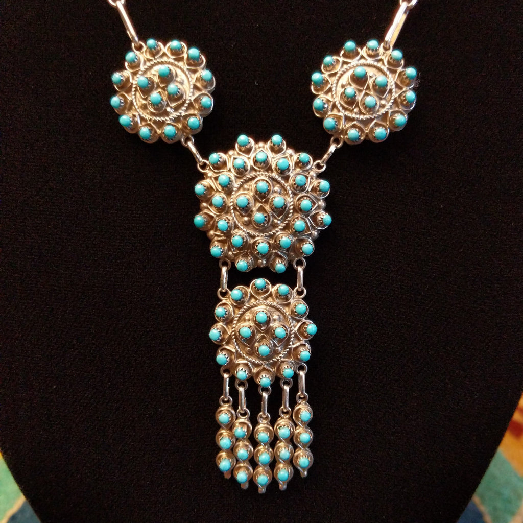 Sterling silver link necklace with drop cluster pendants and turquoise set in notched bezels.
