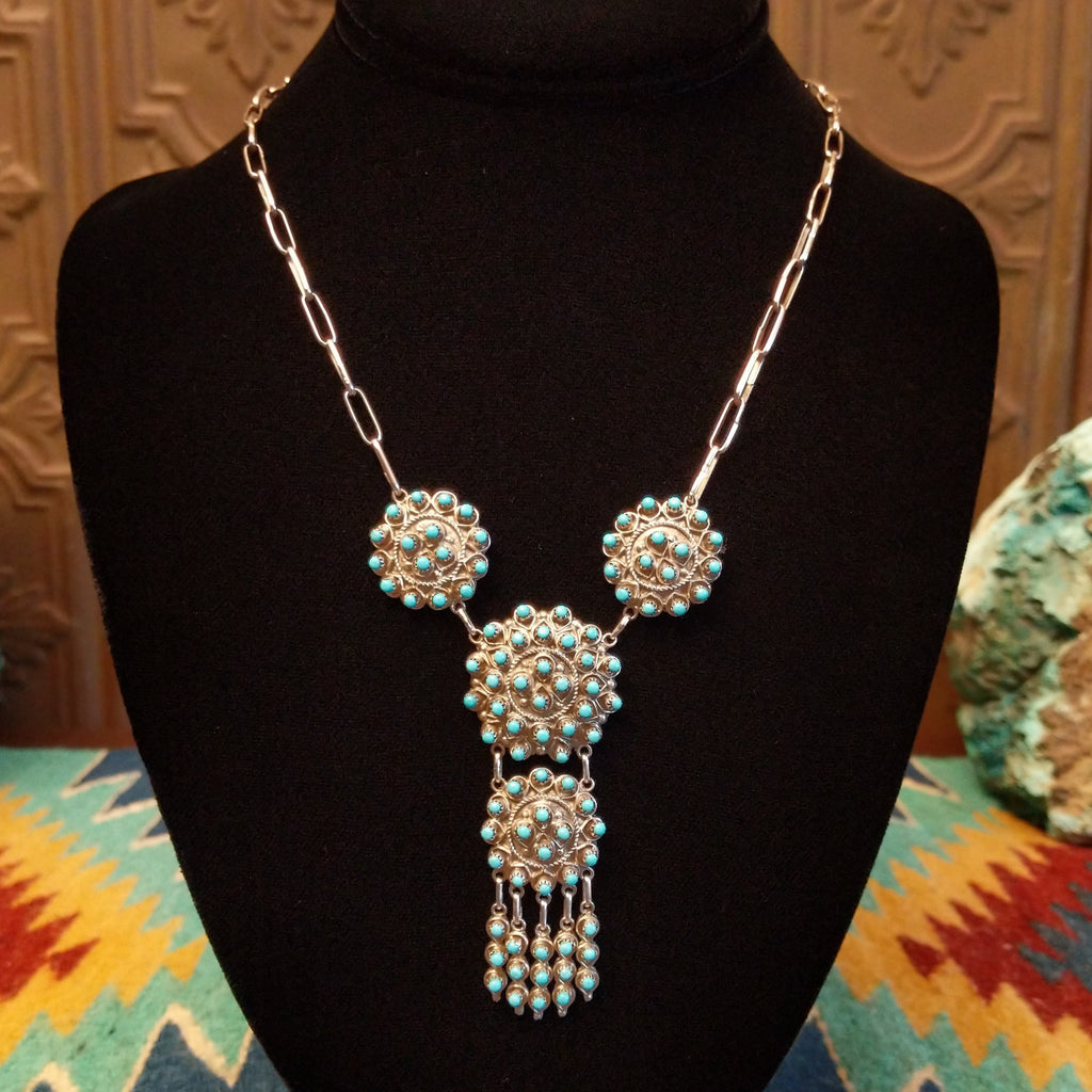 Sterling silver link necklace with drop cluster pendants and turquoise set in notched bezels.