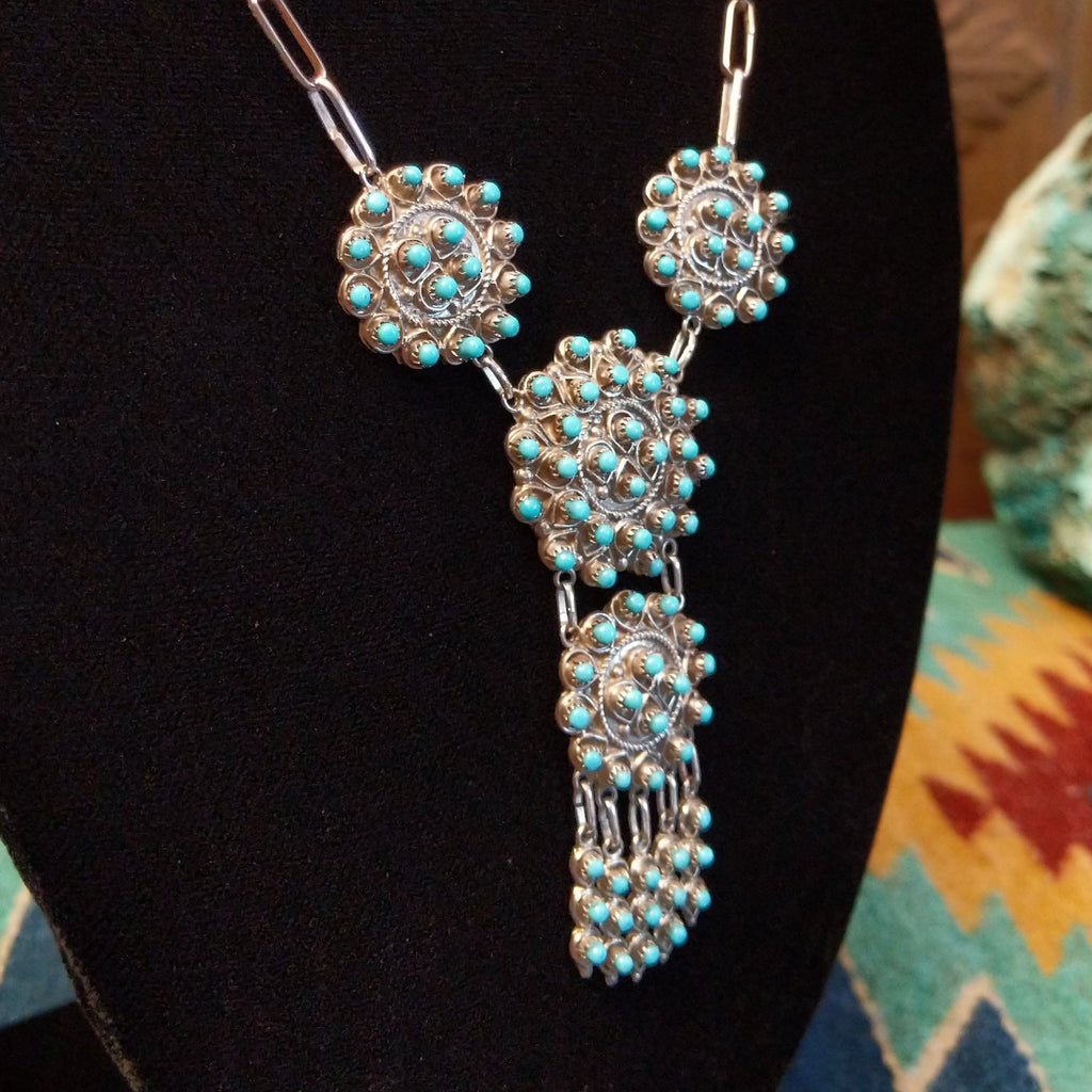 Sterling silver link necklace with drop cluster pendants and turquoise set in notched bezels.