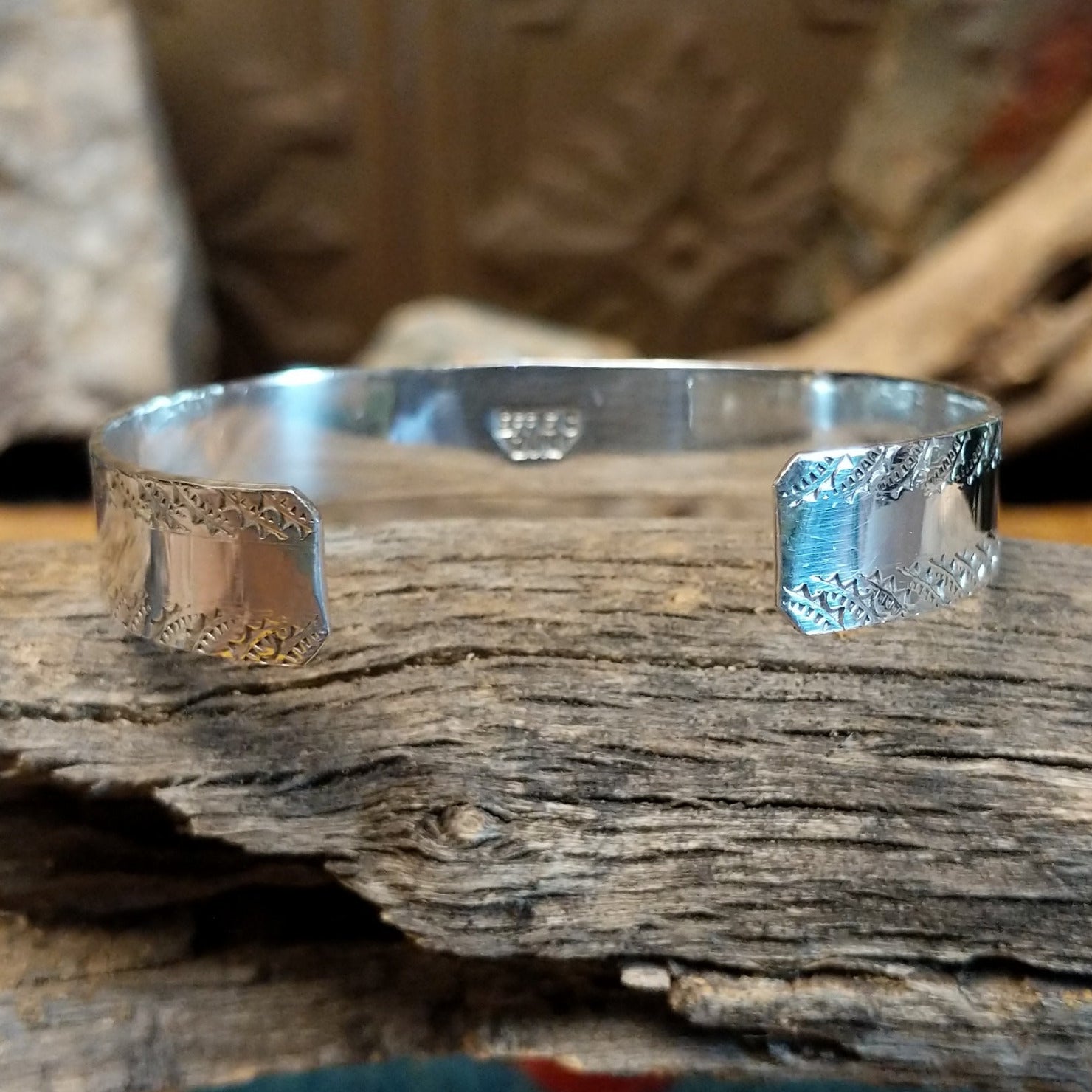 Sterling silver bracelet with turquoise and coral set in notched bezels, featuring the snake design.