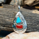 Sterling silver pendant with turquoise and coral set in the bezel, stamped setting and snake design.