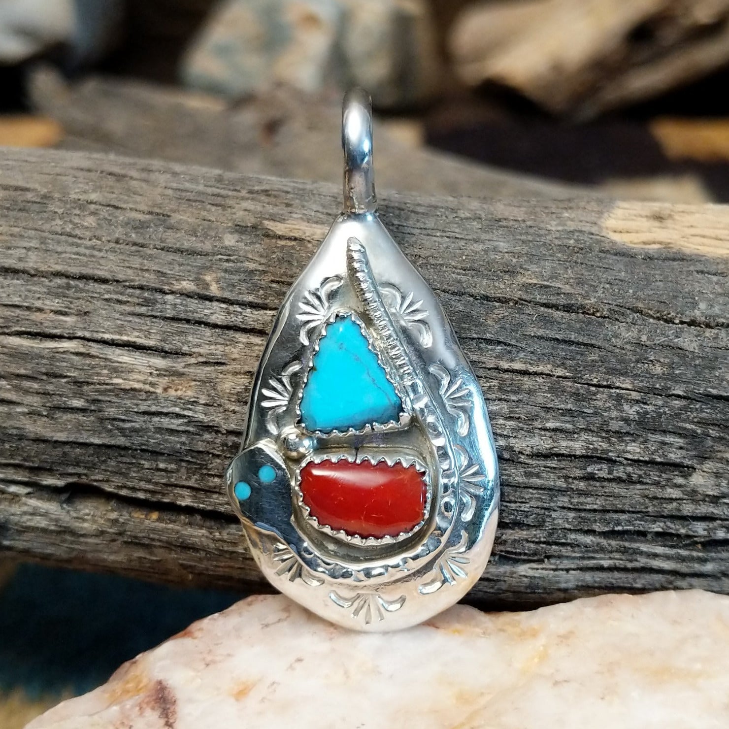 Sterling silver pendant with turquoise and coral set in the bezel, stamped setting and snake design.