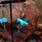 Dangle earring featuring a carved Zuni turquoise bear with pen shell heishi beads, strung on sterling silver wire.