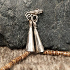 The sterling silver clasp and artist details etched into the silver.
