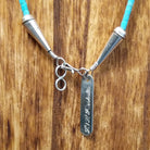 Sterling silver tag and clasp with artist signature etched on the tag.