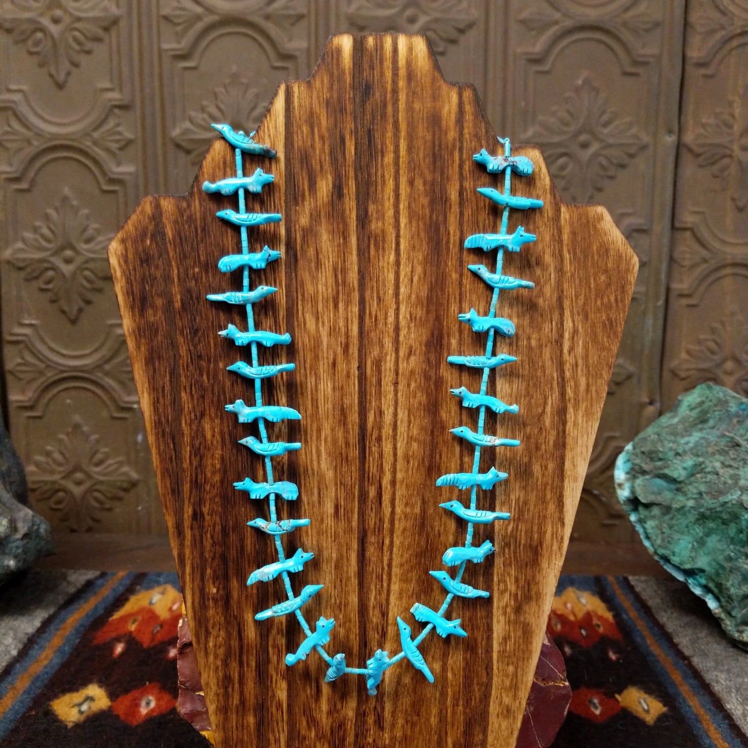 Necklace showcases Zuni turquoise fetish carvings strung with heishi beads.