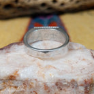 Zuni turquoise rectangle ring by A.Q.J., featuring a rectangular turquoise stone with natural blue tones and matrix patterns set in a handcrafted sterling silver band.  Underside view.