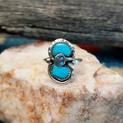 Sterling silver ring with turquoise set in the bezel and snake motif.