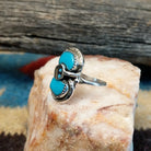 Sterling silver ring with turquoise set in the bezel and snake motif.