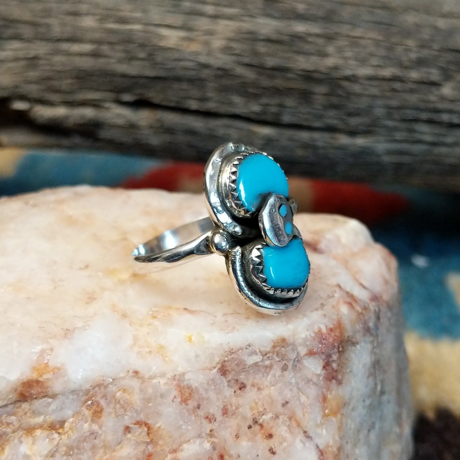 Sterling silver ring with turquoise set in the bezel and snake motif.