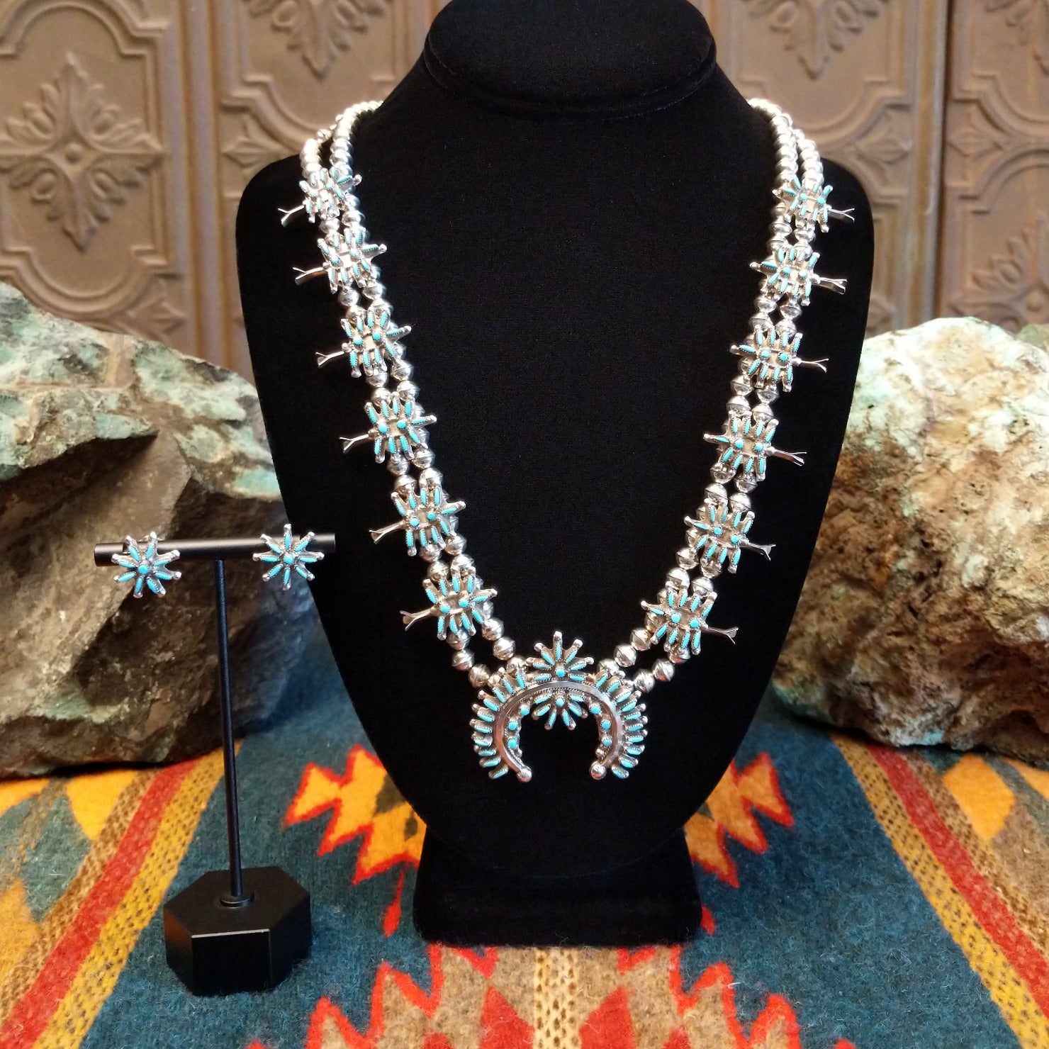 Sterling silver squash blossom naja and necklace and earrings set with turquoise set in individual bezels.