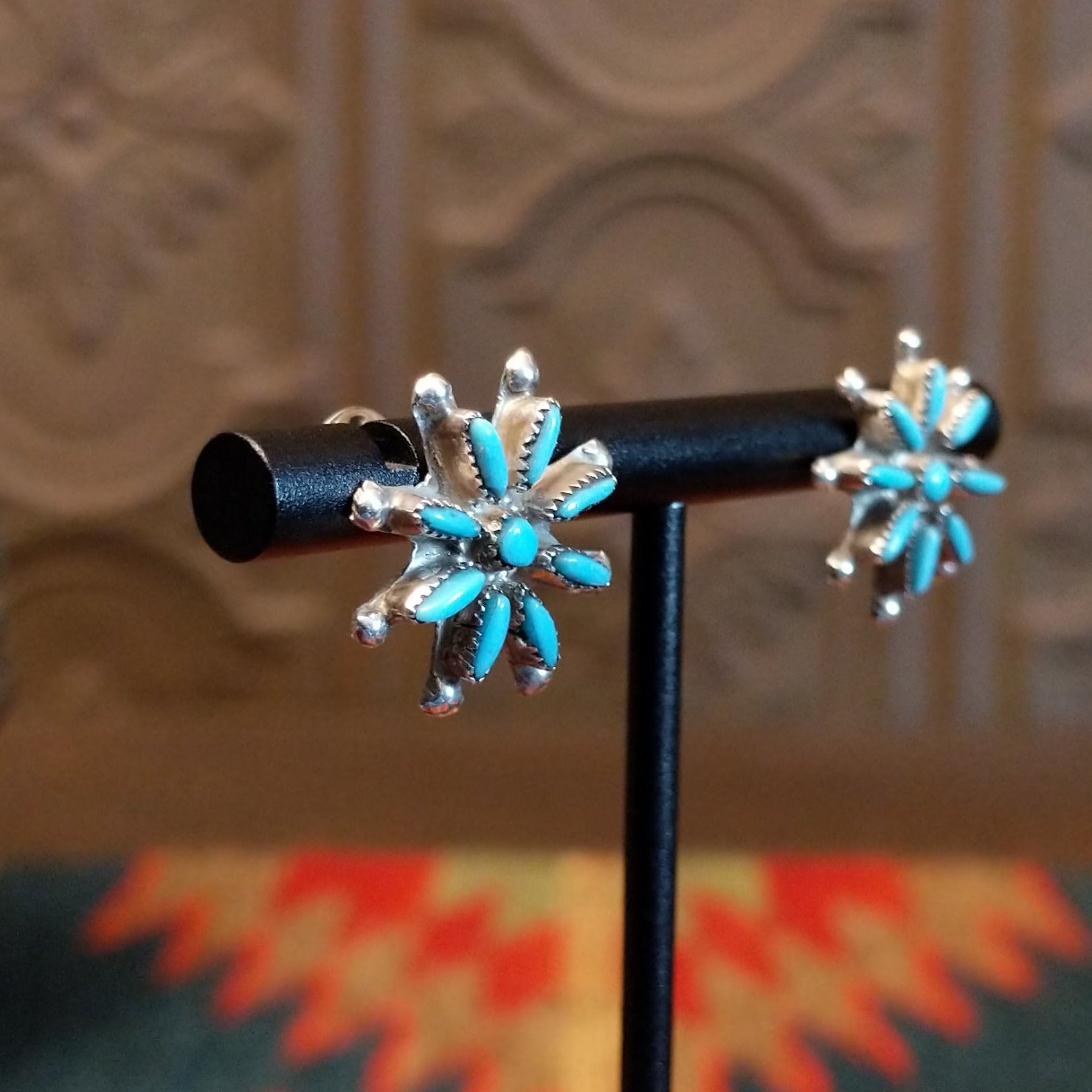 Matching sterling silver earrings with turquoise set in notched bezels.