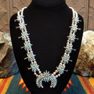 Sterling silver squash blossom naja necklace with turquoise set in individual bezels.