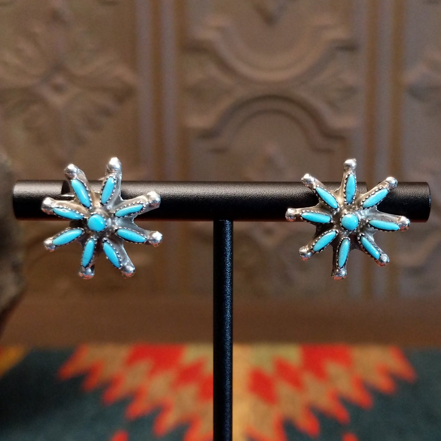 Matching sterling silver earrings with turquoise set in notched bezels.