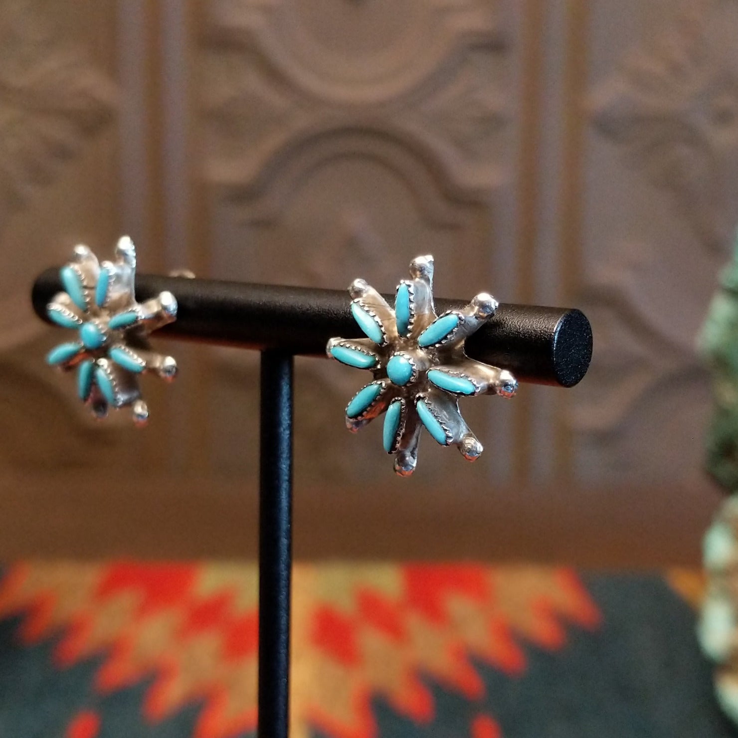 Matching sterling silver earrings with turquoise set in notched bezels.
