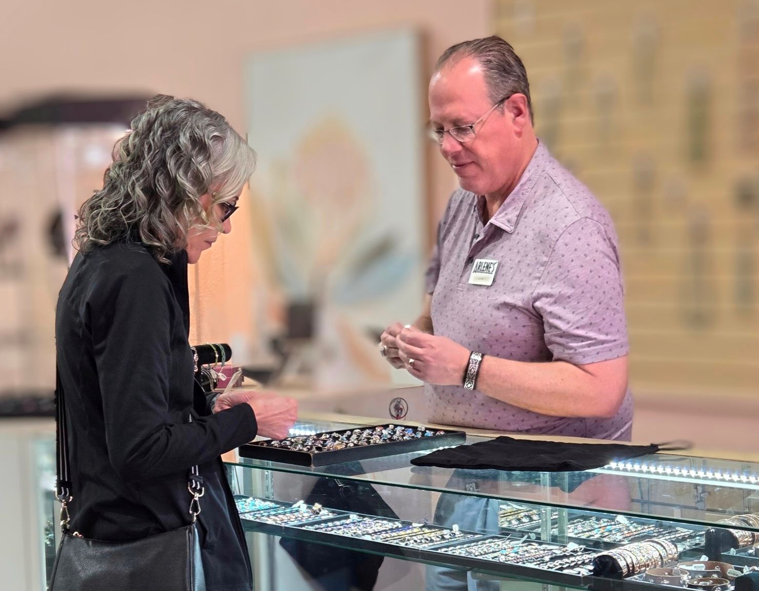 Arlene's owner, Adam Klein showing a customer Native American rings.