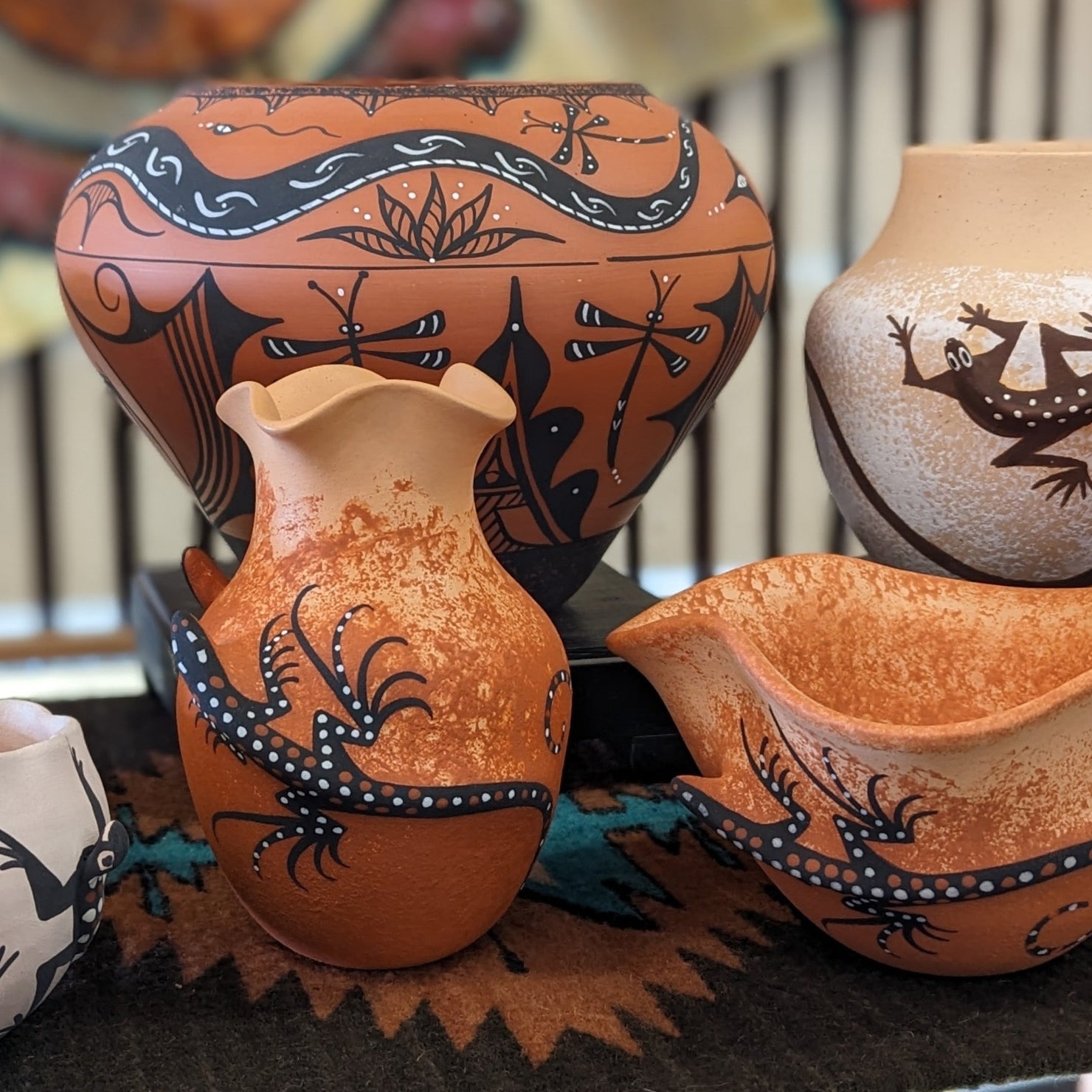 A selection of Zuni pottery pieces with nature motiffs.