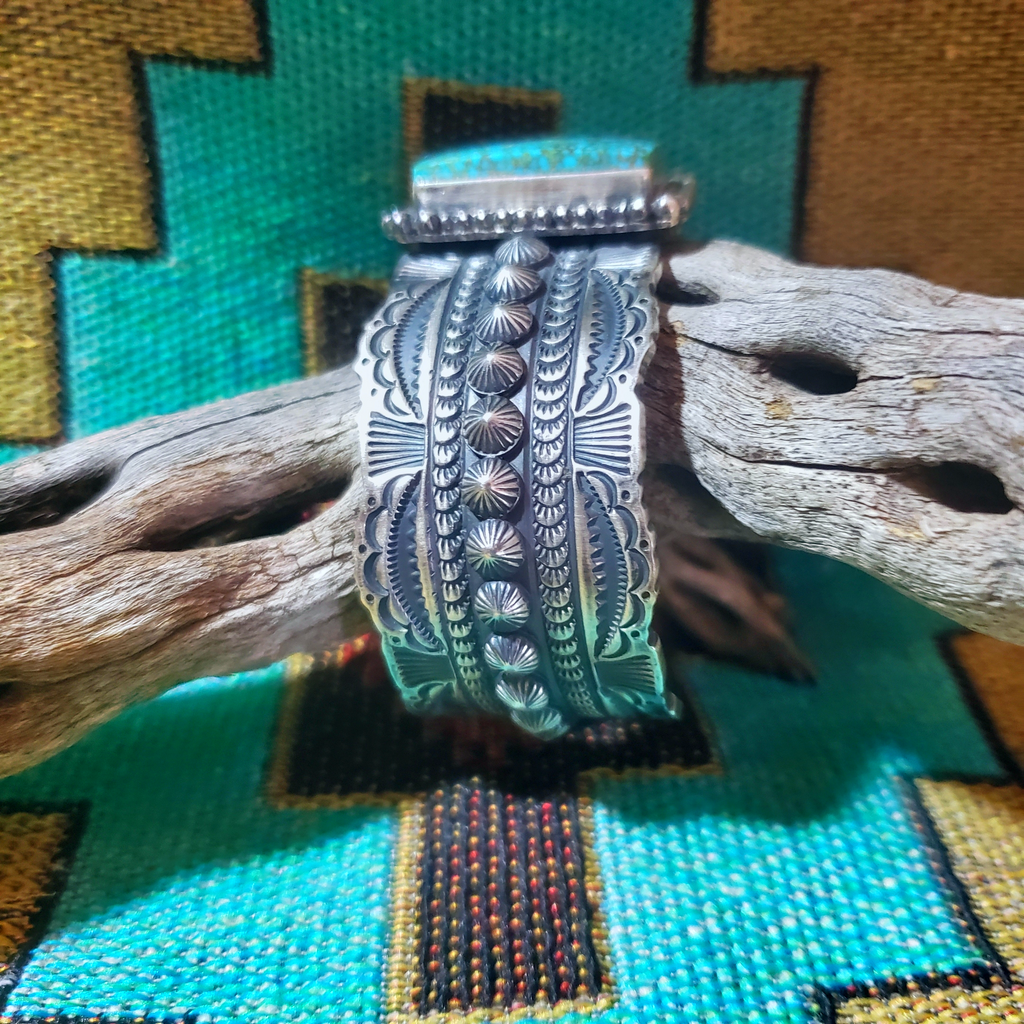 Turquoise and tooled cuff bracelet. Bracelet is made of Kingman Turquoise The width of the band is approximately 1" The bracelets inside circumference measures 5 3/4" plus a 1" opening (can be adjusted up or down to fit various wrist sizes)